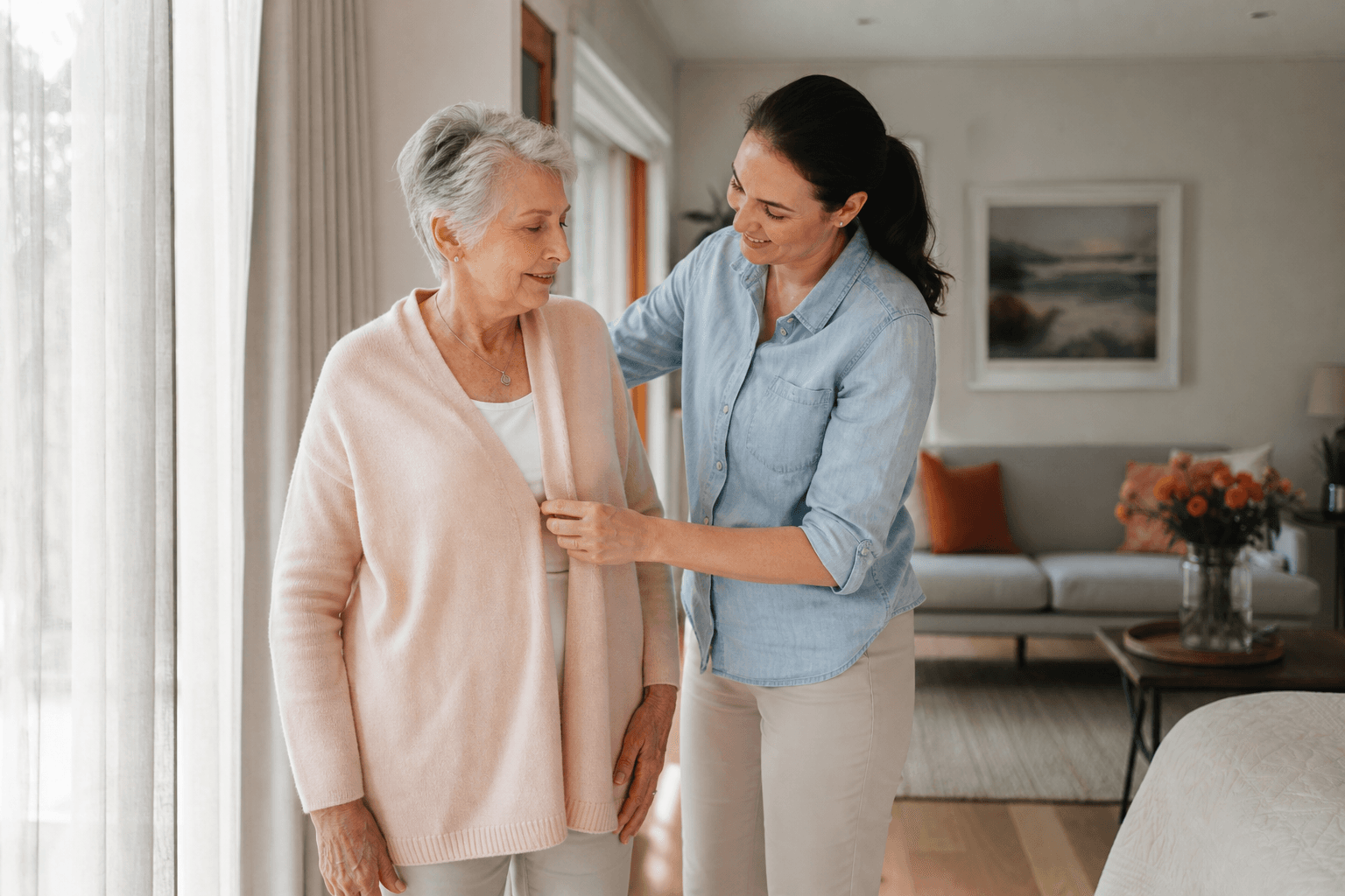 A home-care worker supporting an older woman with her morning routine