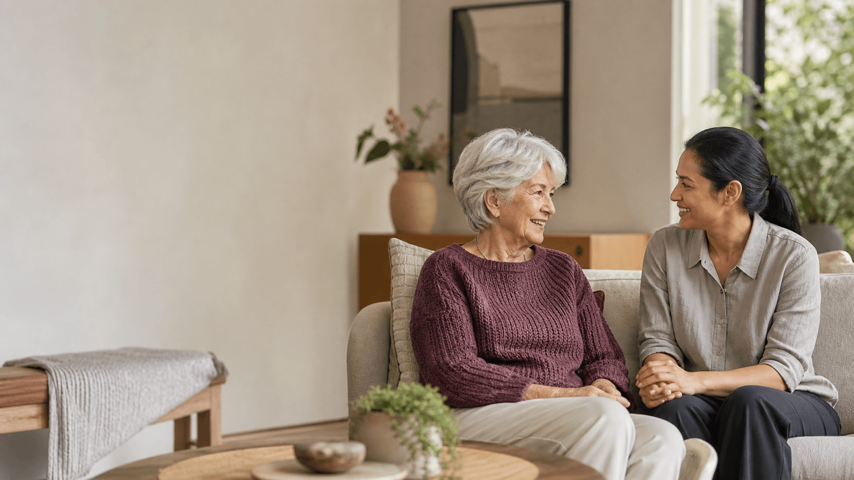 An older woman and her home-care worker talking together